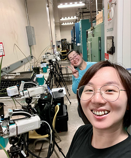 Yu Wang and a colleague in a lab space.