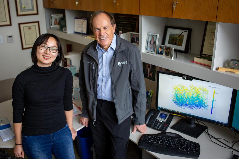 Yu Wang and Steve Model pose next to the model pulled up on a monitor. 