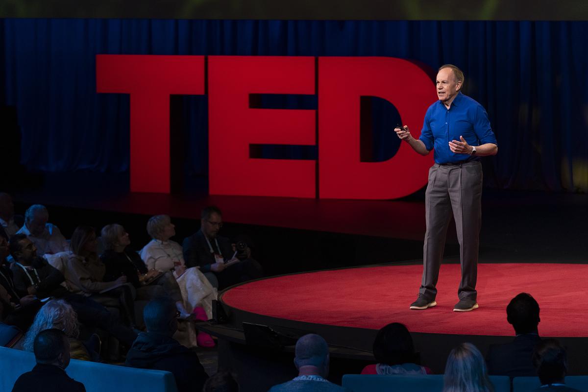 Steve Long speaking on a stage with the word TED to his right.