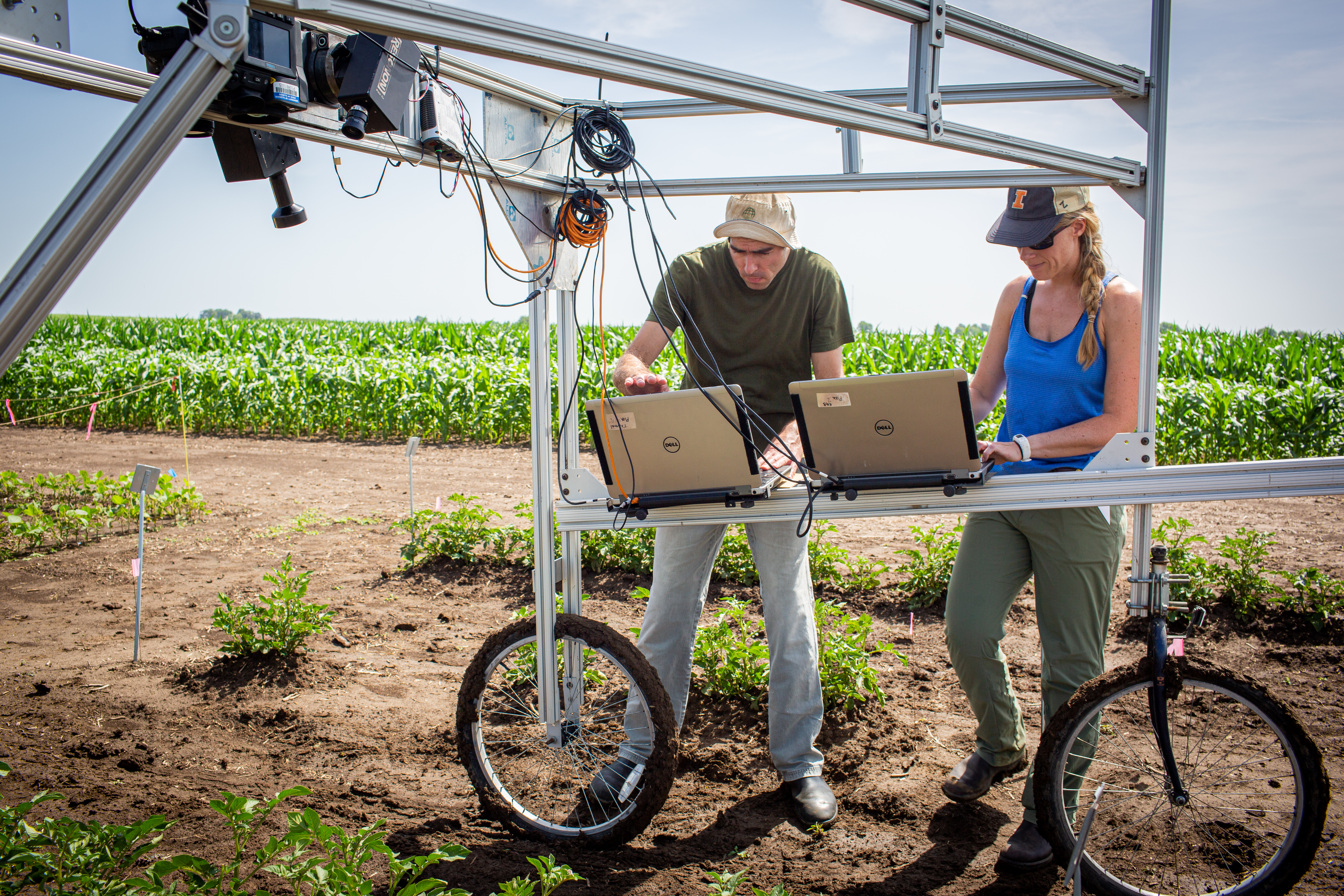 University of Illinois Research Technician Evan Dracup (left) and Postdoctoral Researcher Katherine Meacham-Hensold (right) use hyperspectral cameras to screen entire research plots for high-yielding photosynthesis traits. Two recent publications are making this technology available to more scientists.