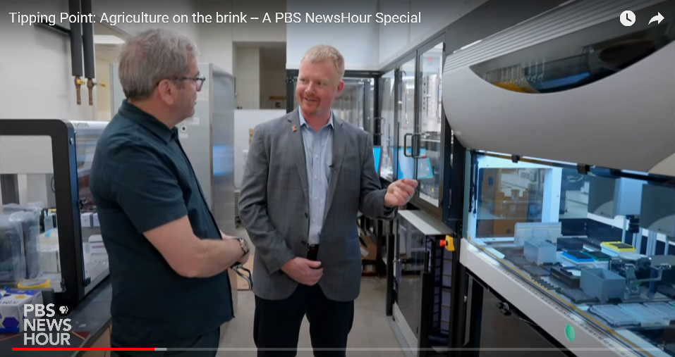 Andrew Leakey shows PBS NewsHour host Miles O'Brien around his lab space.