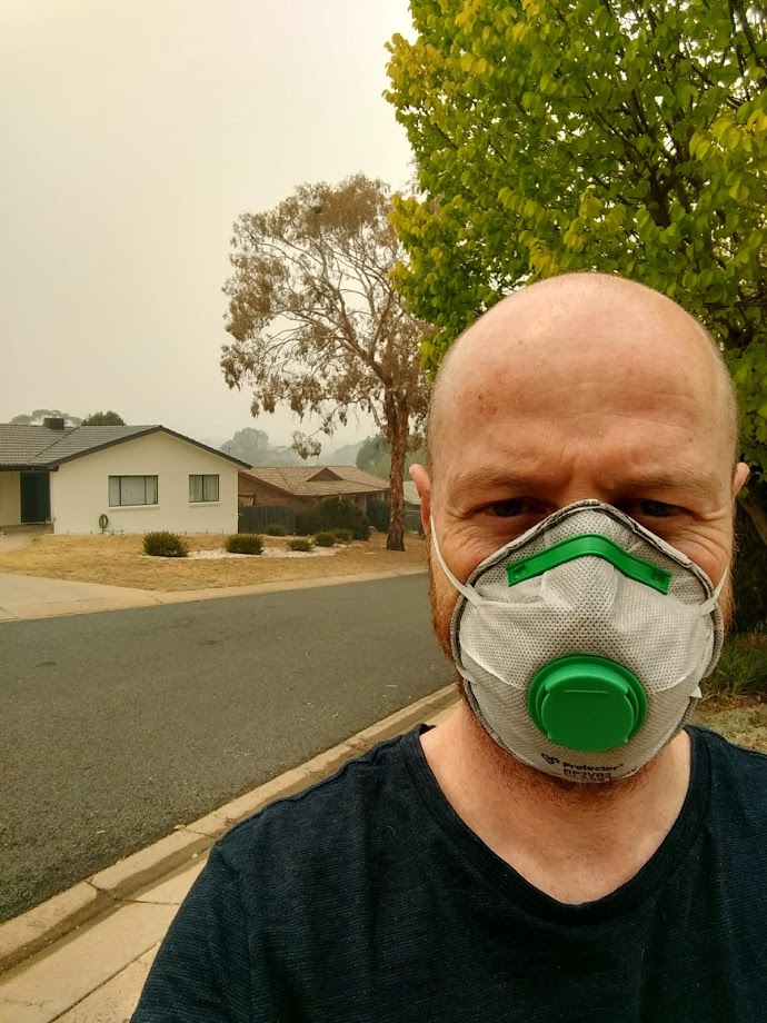 Ben Long wears a mask in the smoke haze.