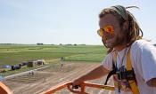 David Drag poses in a cherry picker overlooking the field trials. 