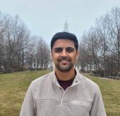 Portrait of Bikram Poudel wearing a grey sweater.