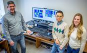 Research team stands by picture of hyperspectral data.